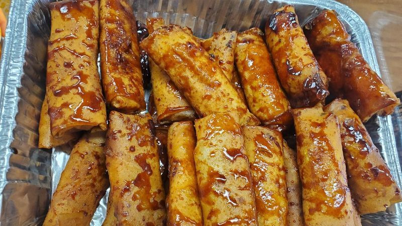 A tray of food with sauce on it is sitting on a table.