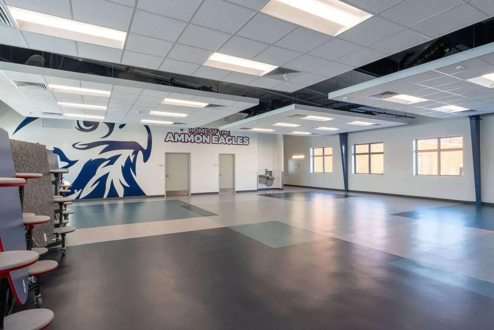 Empty school cafeteria with blue, white, and gray accents