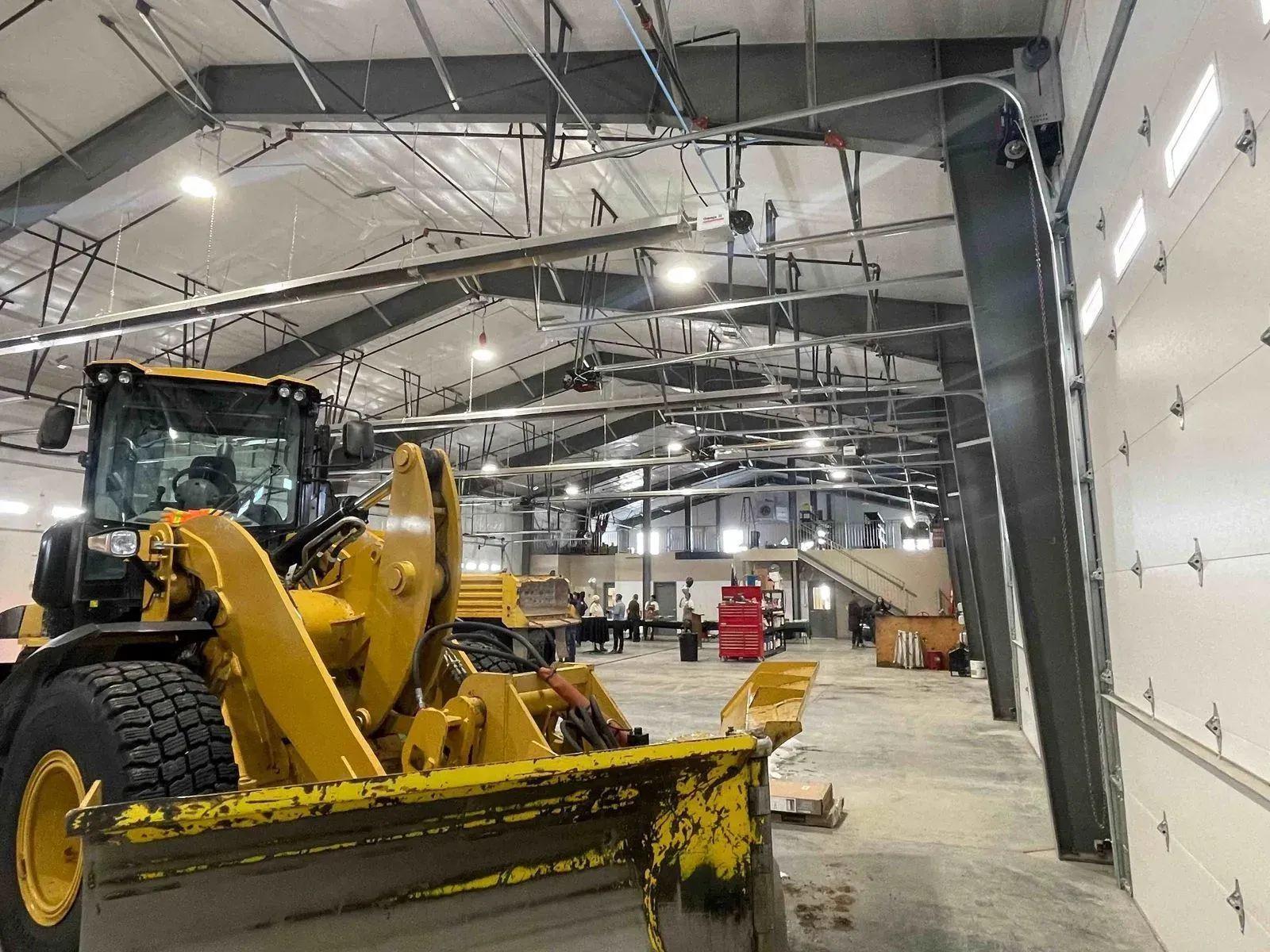 Yellow construction vehicle inside a large warehouse