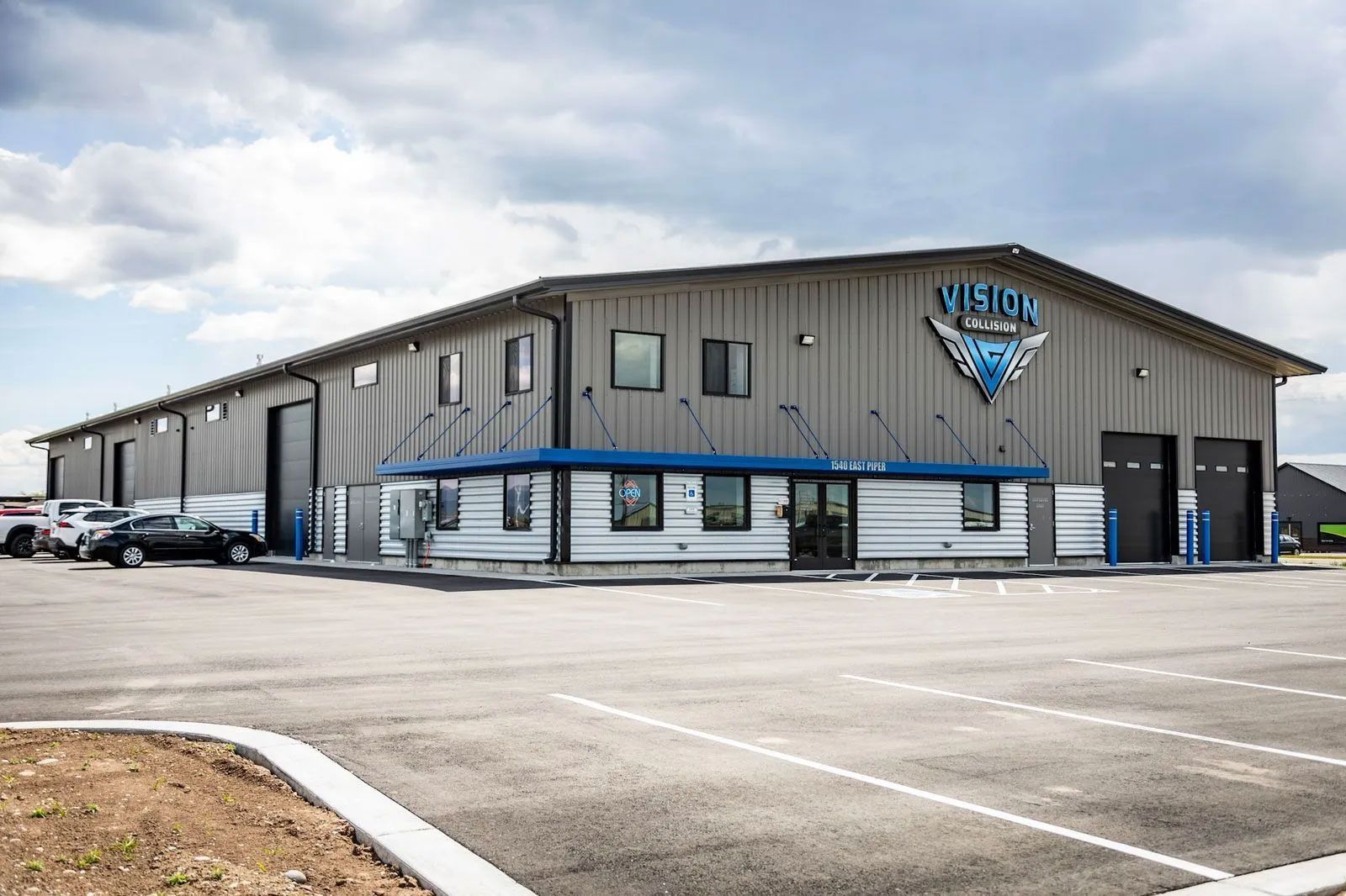 Large industrial building with parking lot;