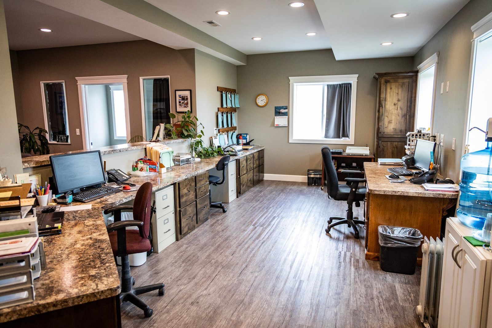 A large office with lots of desks and chairs.