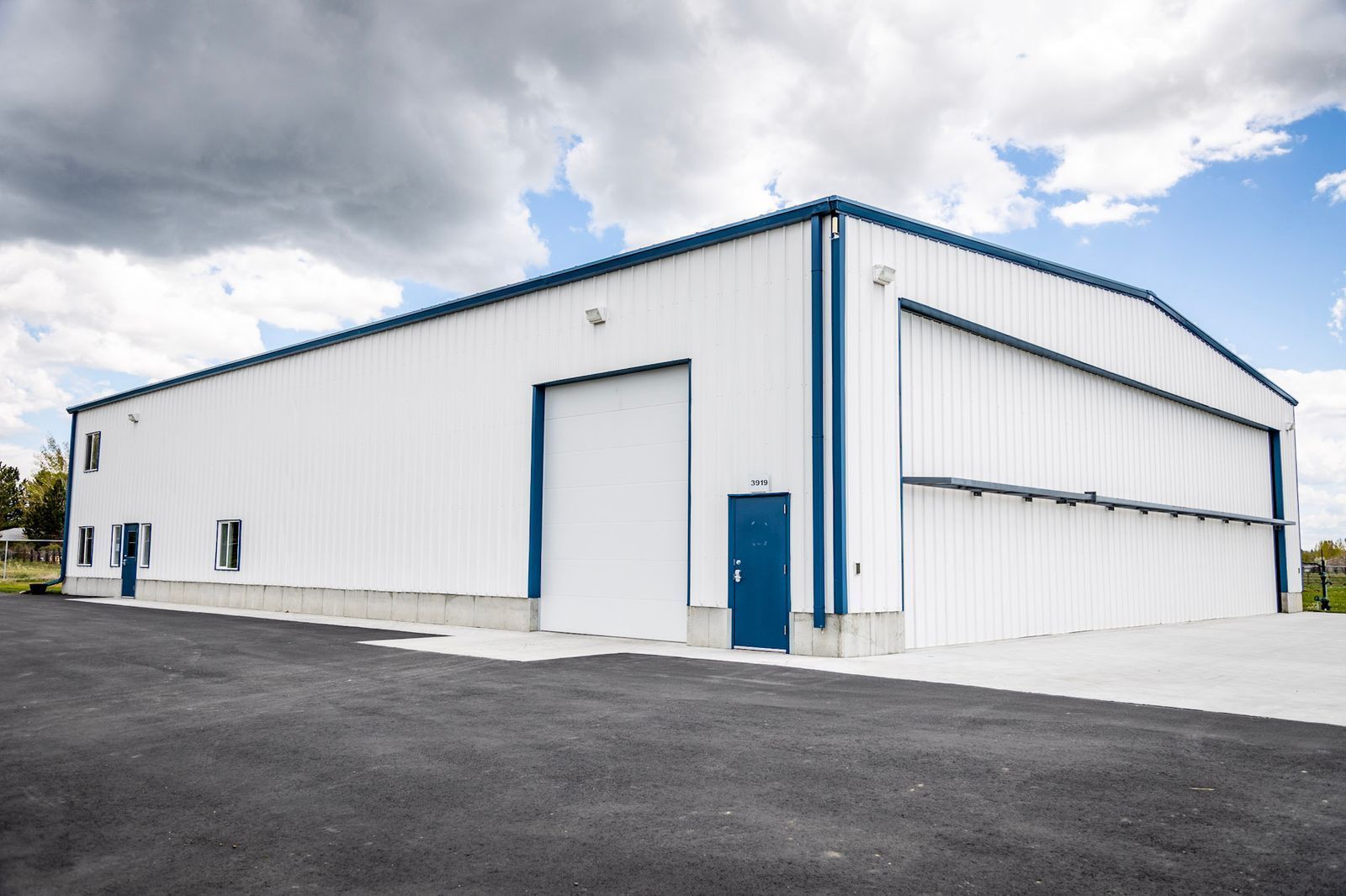 A large white building with blue trim and a blue door