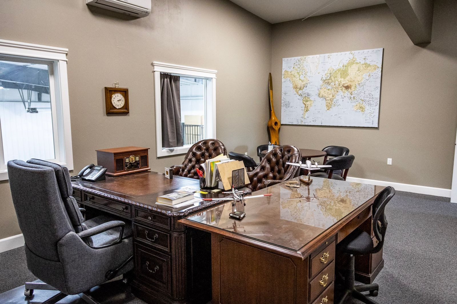 There is a map of the world on the wall above the desk.