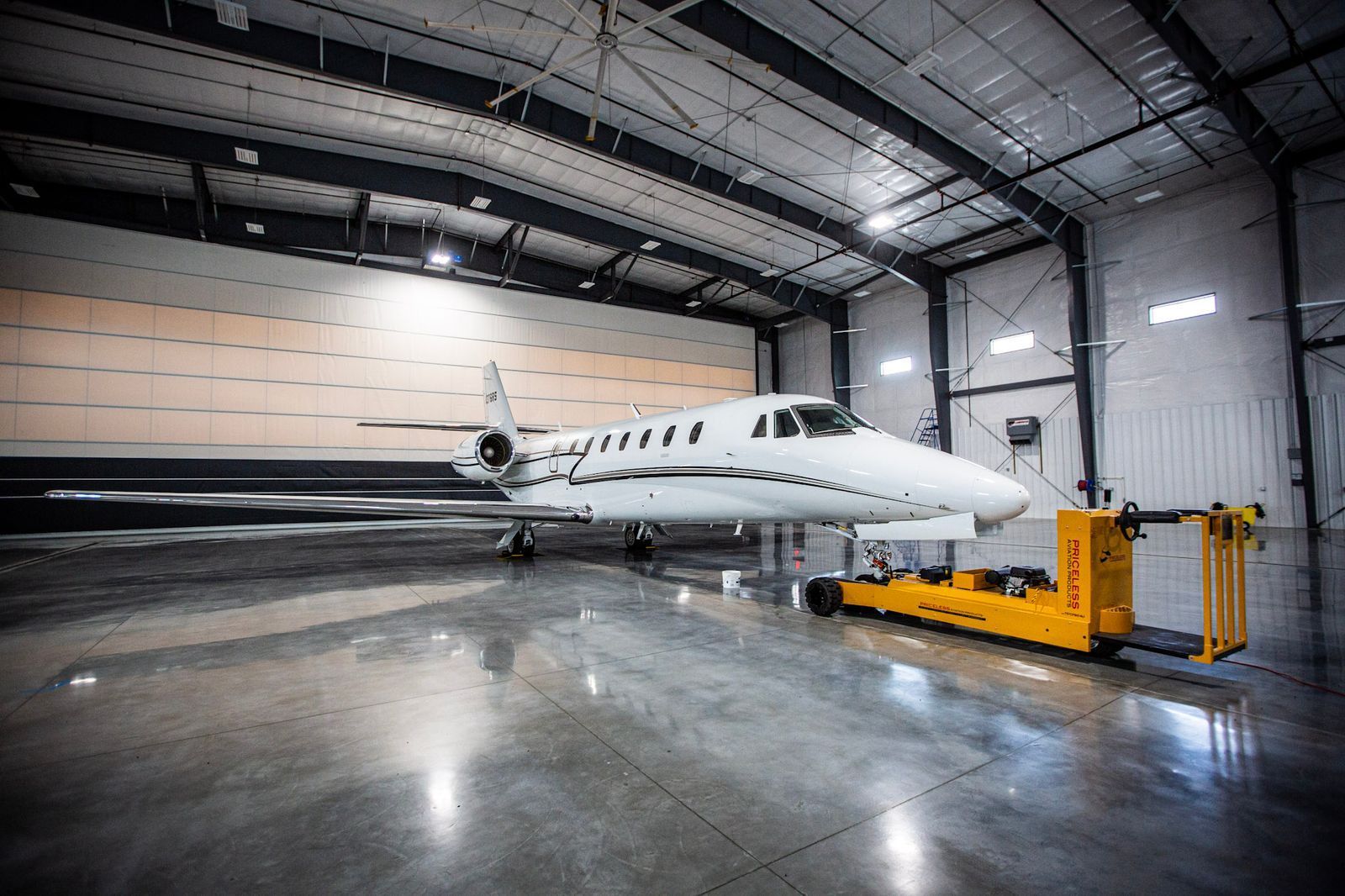 A small jet is parked in a hangar.
