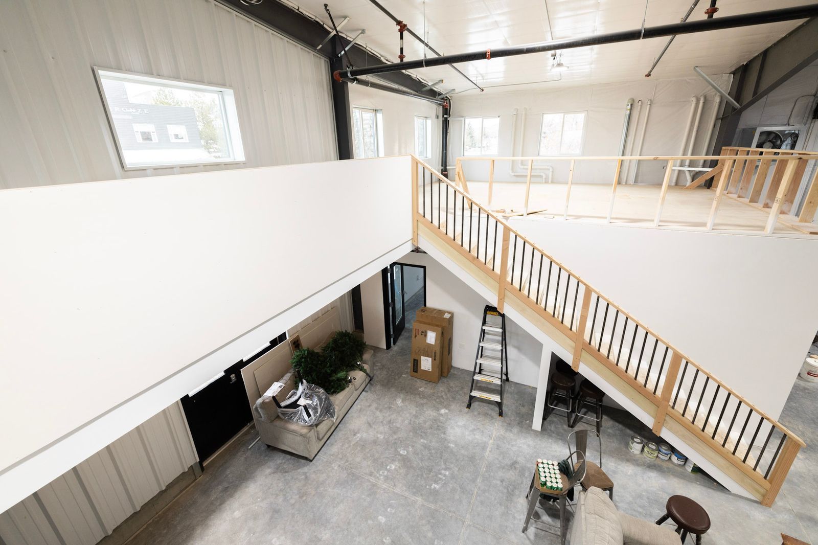 An aerial view of a living room with a staircase leading to the second floor.