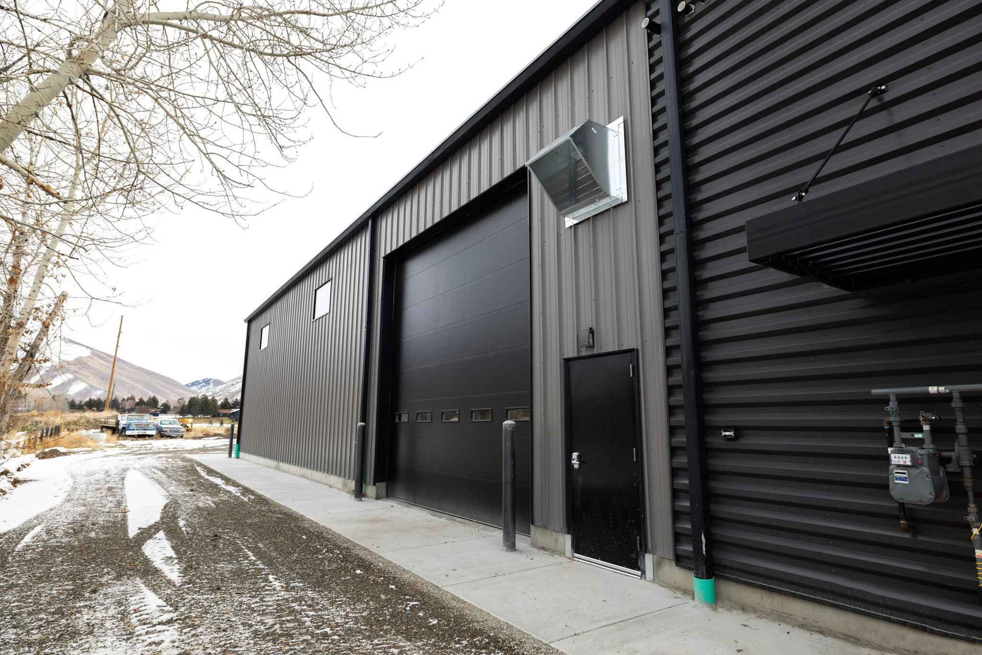 A large black building with a lot of windows and doors.