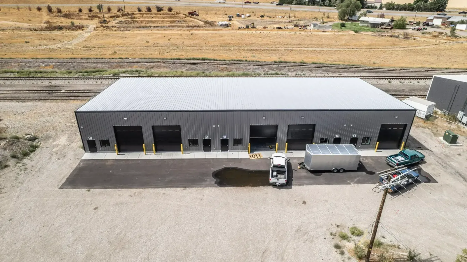 An aerial view of a large building with a truck parked in front of it.