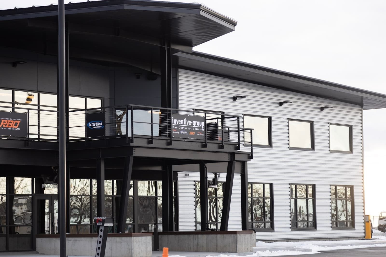A large white building with a balcony and a lot of windows.