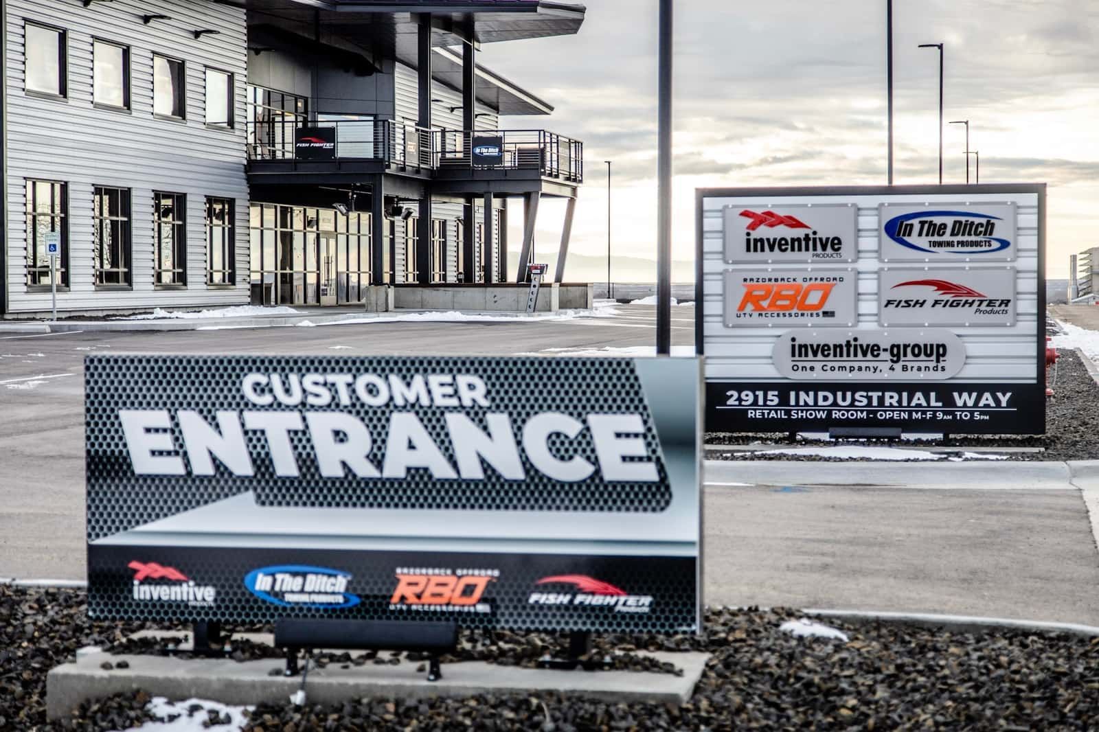 A customer entrance sign in front of a building