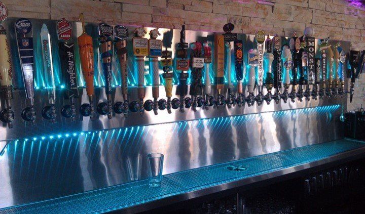A bar with a lot of beer taps on it