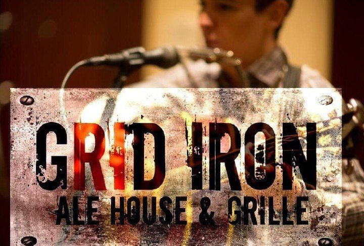 A sign for grid iron ale house and grille