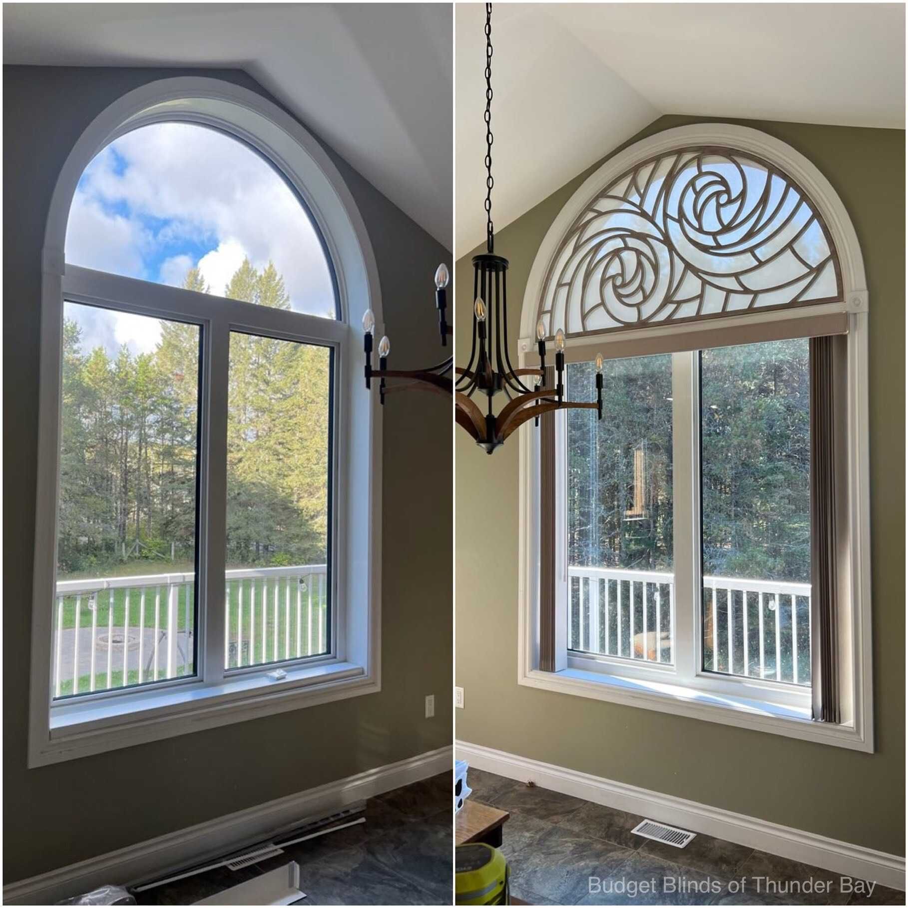 Two arched windows in a bright room with a hanging chandelier and a view of trees and a deck outside