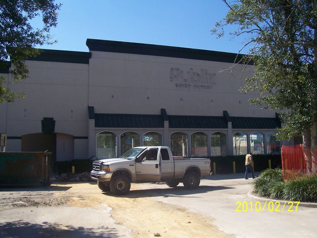 Silver truck infront of the building