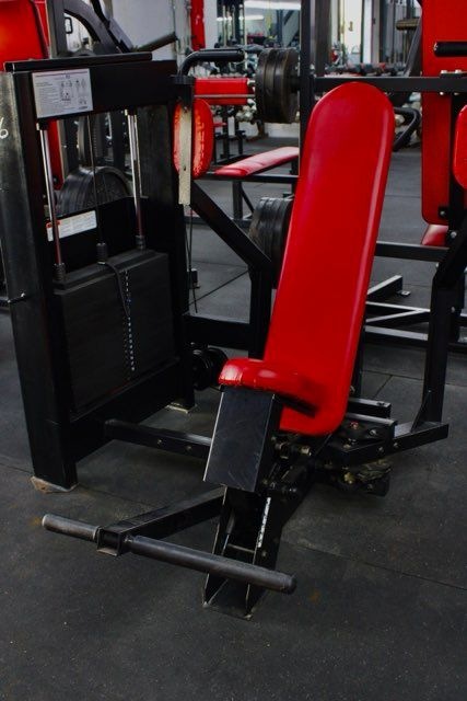 Red and black weight machine in a gym.