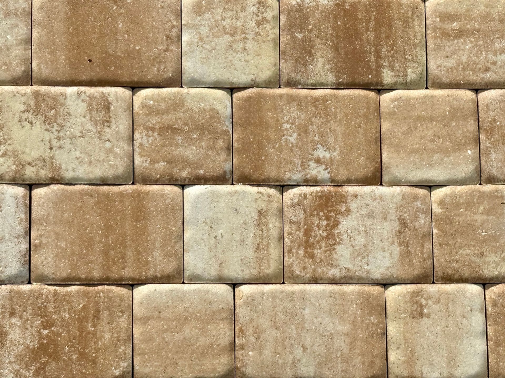 A close-up of a brown and white brick wall.