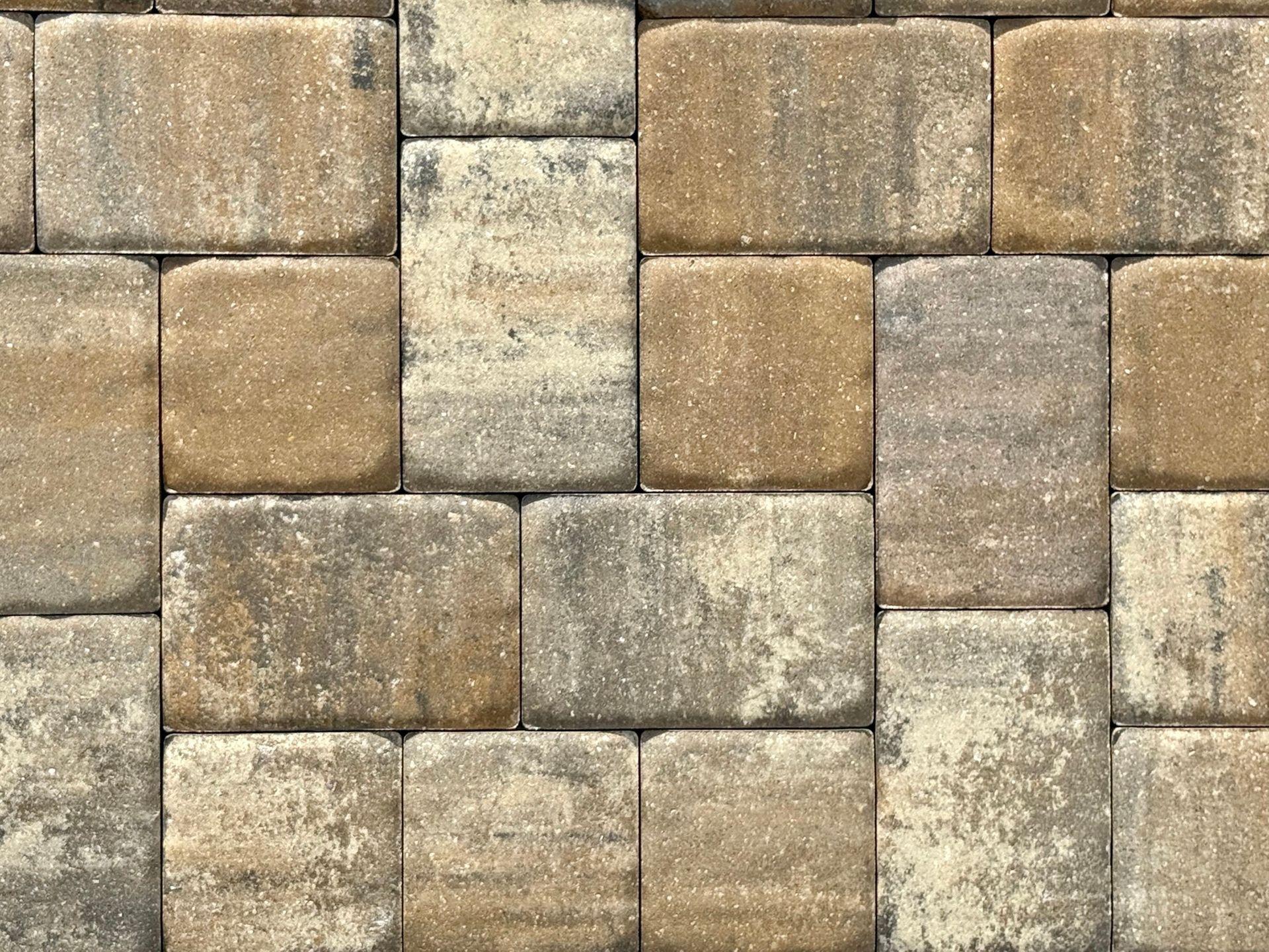 A close-up of a brick wall with a pattern of squares.