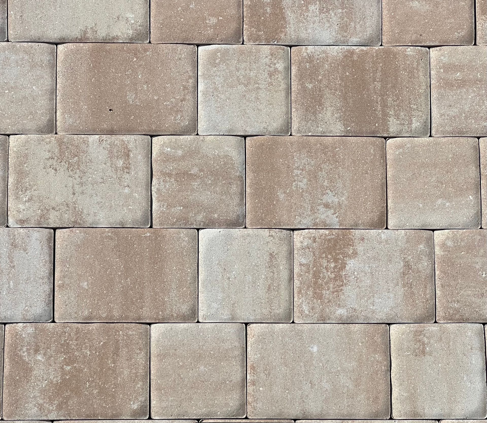 A close-up of a brown and white brick wall.