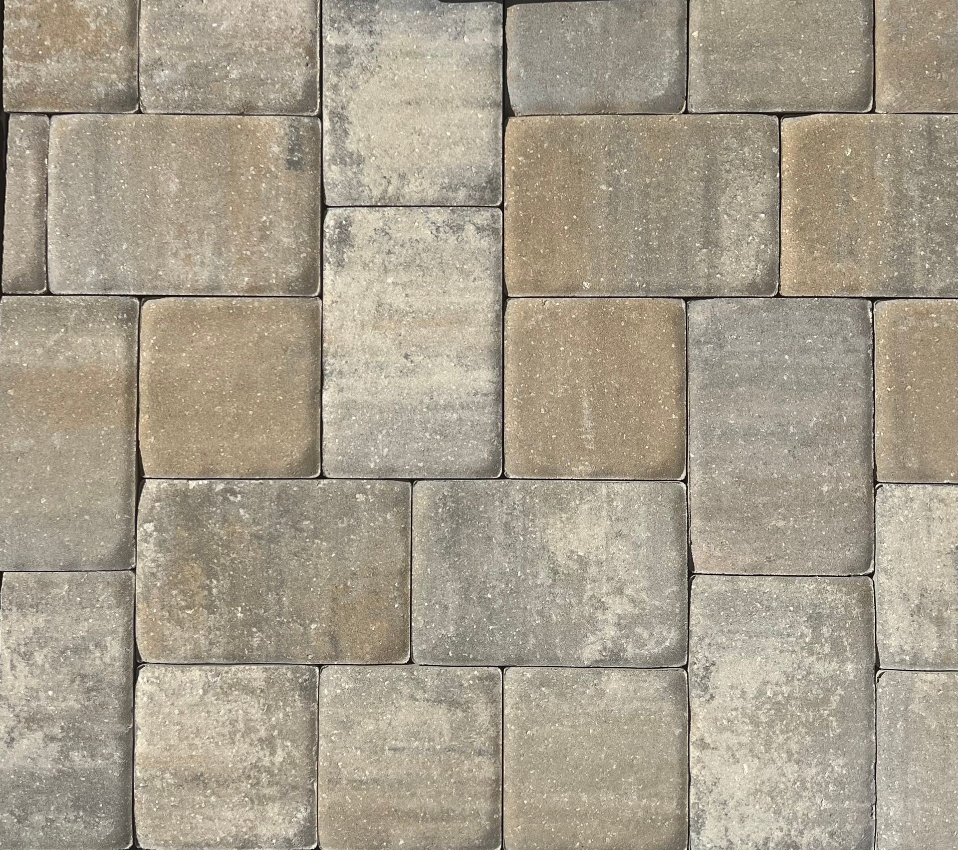 A close-up of a brick wall with a pattern of squares.