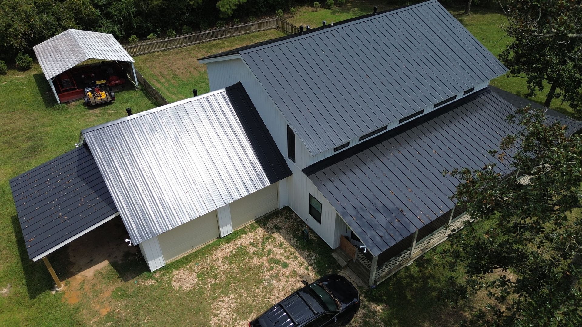 An aerial view of a house with a black truck parked in front of it.