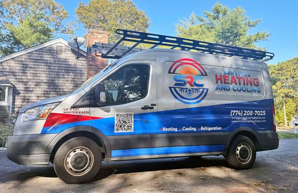 Service van for SRC Heating and Cooling, parked outside a house with trees.