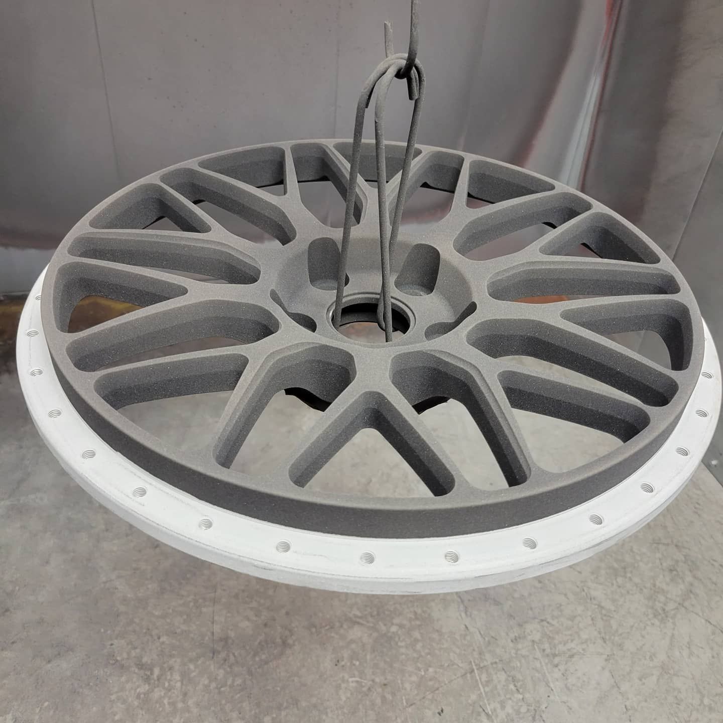 A close up of a wheel hanging from the ceiling