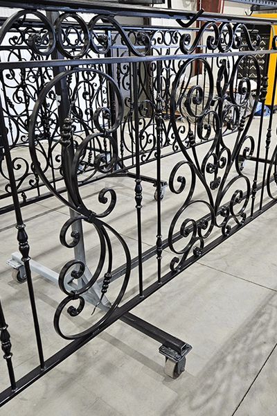 A wrought iron railing is sitting on top of a table.