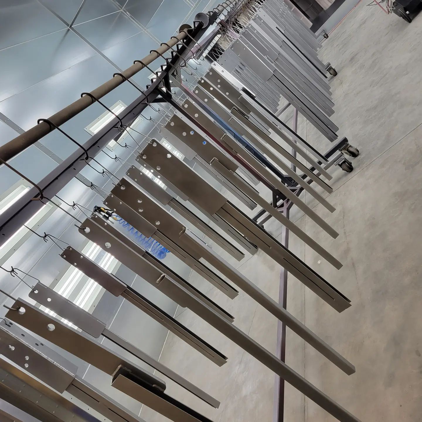 A bunch of metal pieces are hanging on a rack