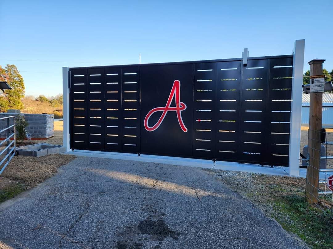 A black gate with the letter a painted on it.