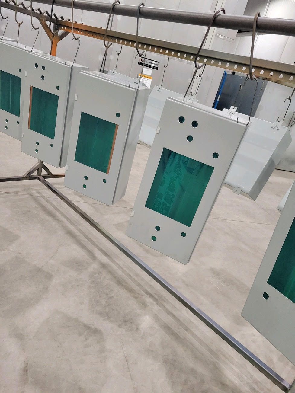 A bunch of boxes are hanging on a rack in a room.