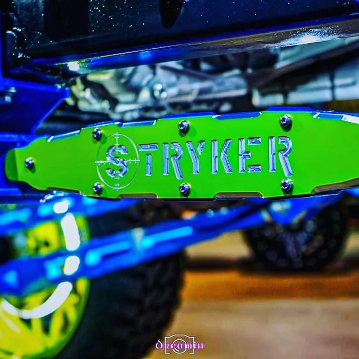 A blue truck with a green license plate that says Stryker