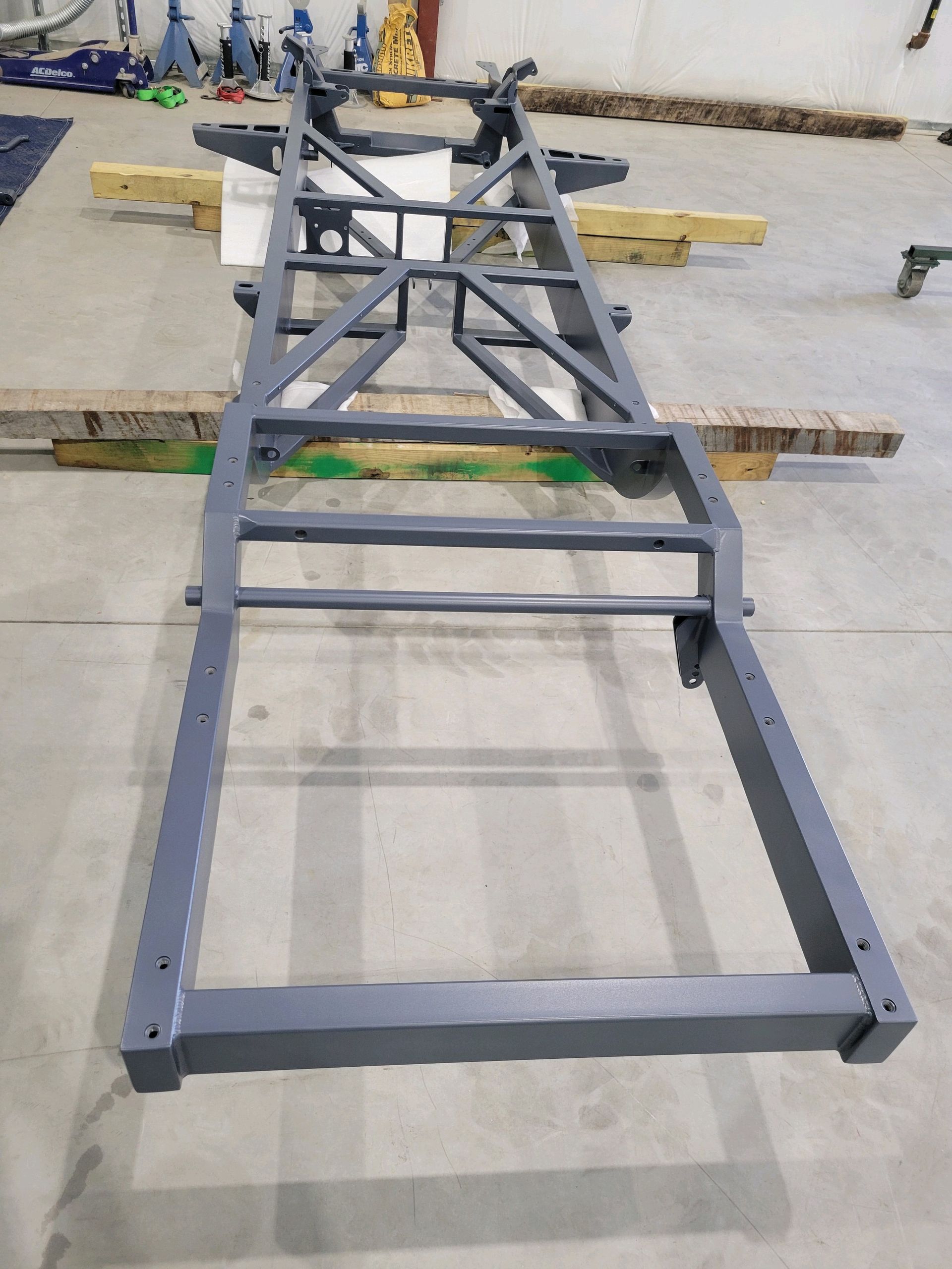 A metal frame is sitting on top of a wooden table