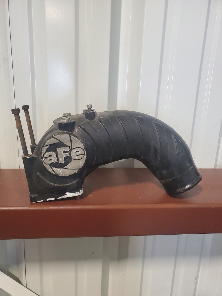 A black pipe with the word afe on it is sitting on a shelf.
