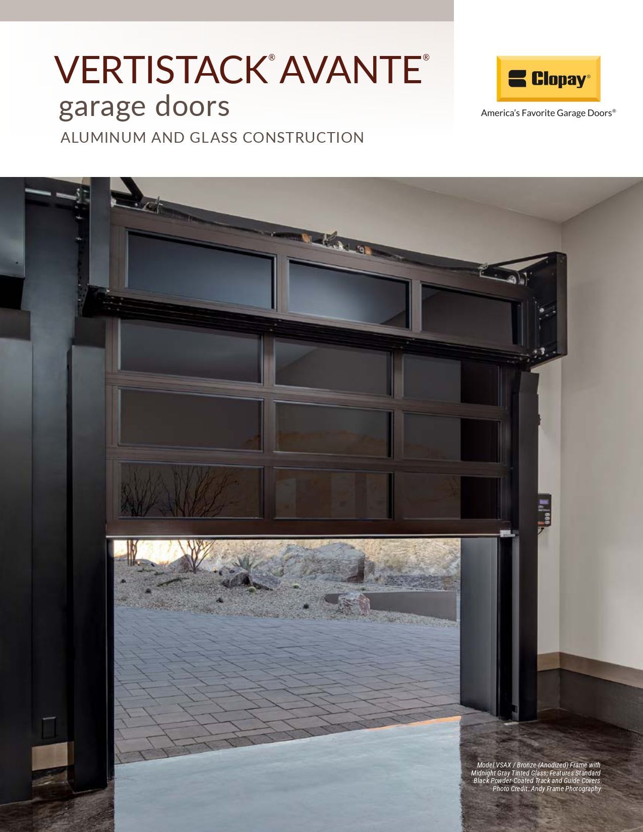 Open garage door showing dark wood-look sectional panels and daylight outside