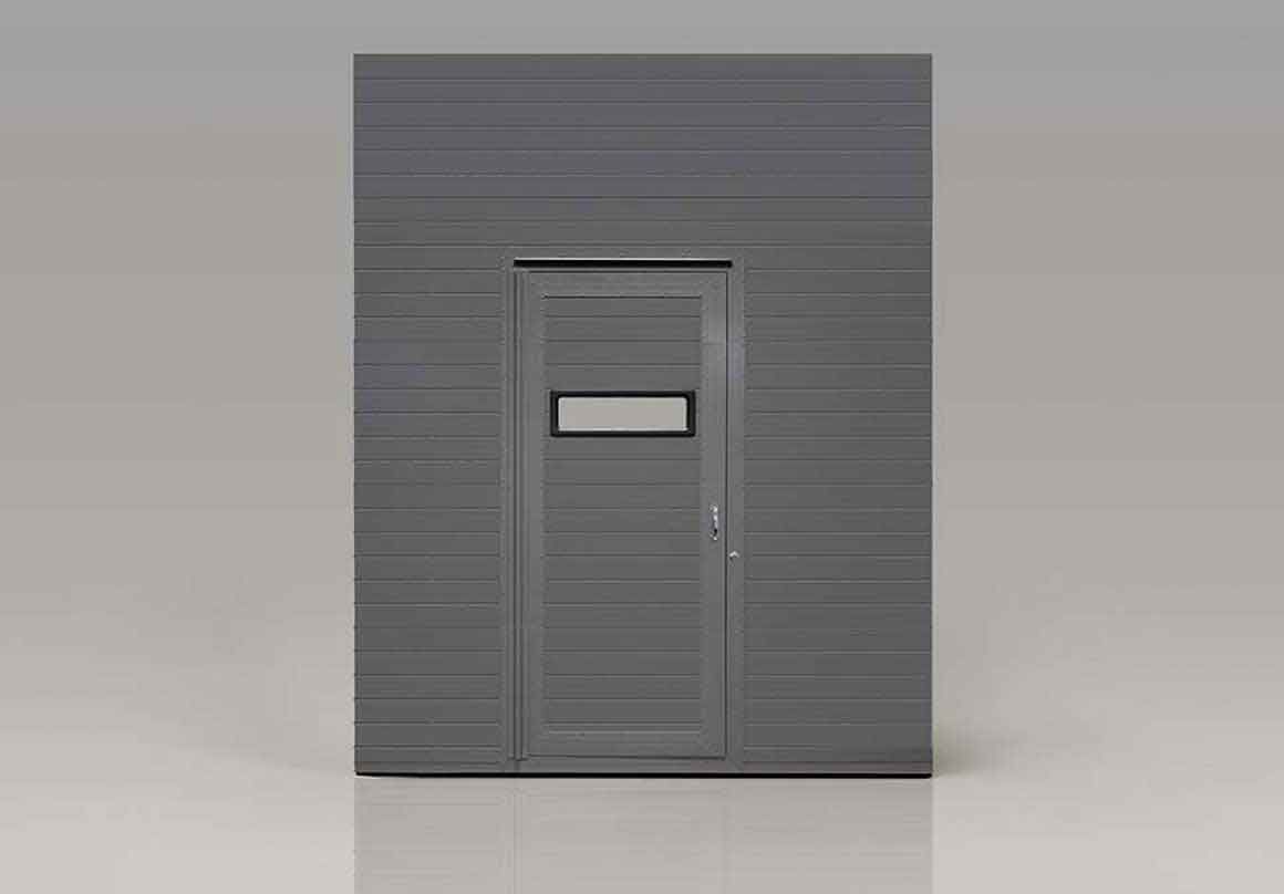 Gray building facade with door and small window.