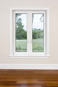 A window with brown hardwood flooring