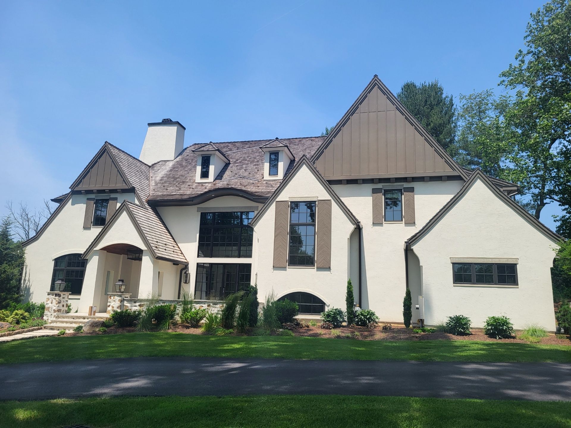 Large cream-colored house with a steep roof
