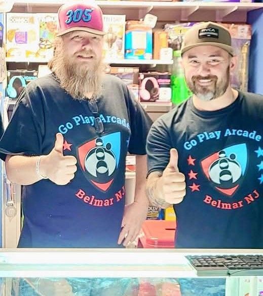 Two men at an arcade, wearing