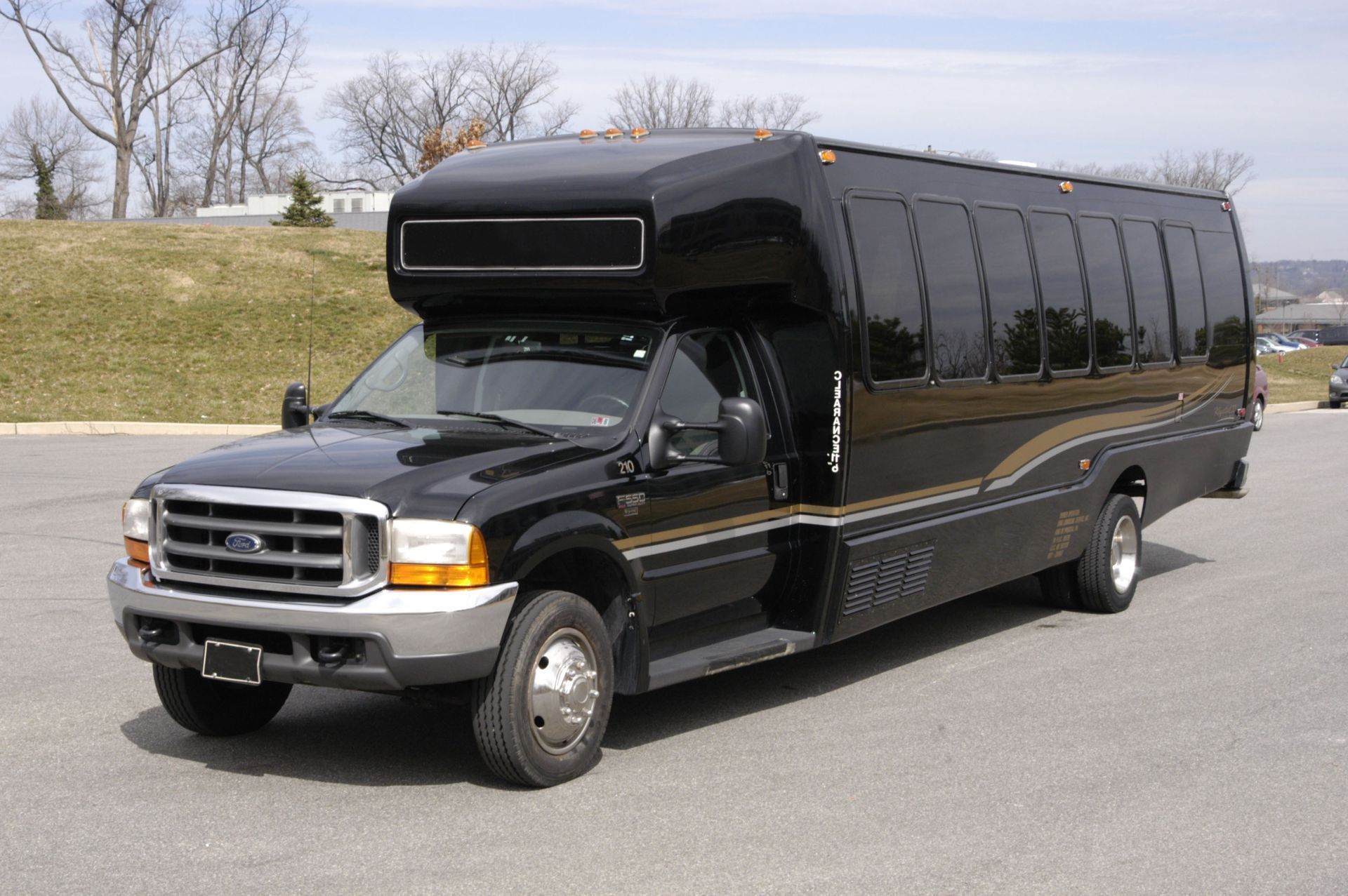 A black bus is parked on the side of the road.