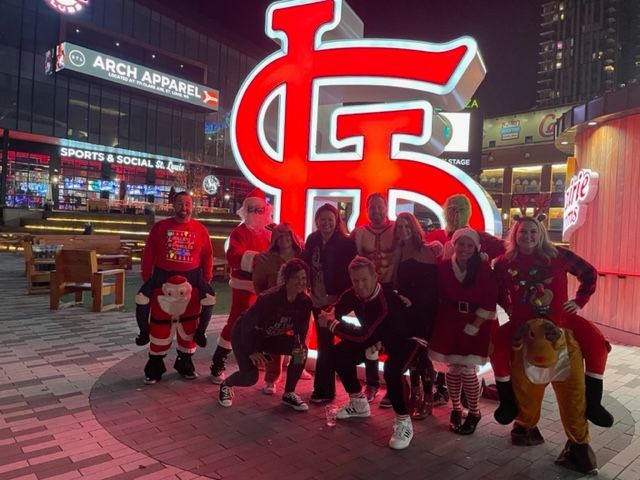 a group of people standing in front of a sign