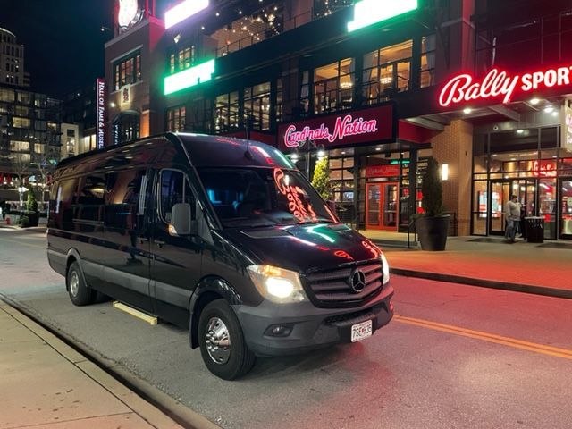 a black van is parked on the side of the road in front of a building