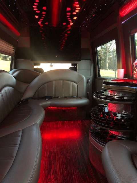 the inside of a limousine with red lights on the ceiling