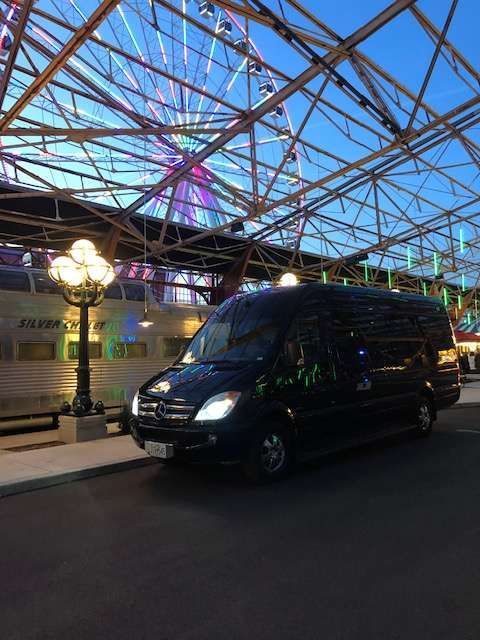 a black van is parked on a sidewalk