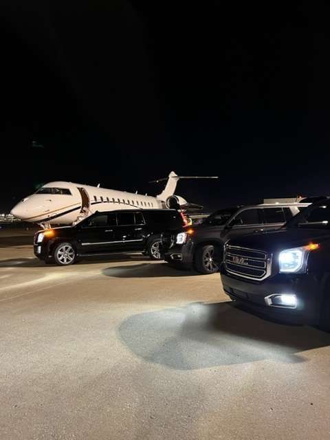 a gmc suv is parked in front of a private jet