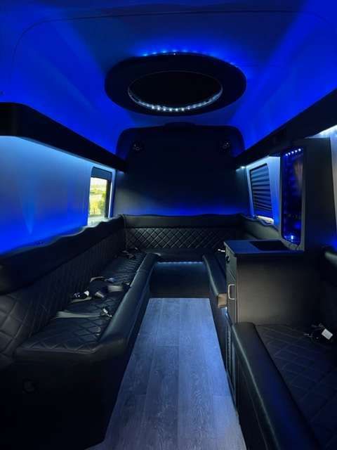 the inside of a limousine with blue lights on the ceiling