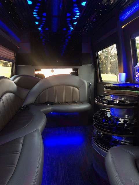 the inside of a limousine with blue lights on the ceiling