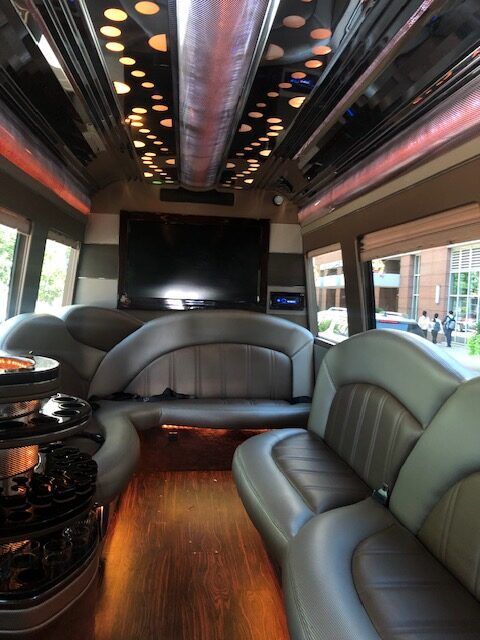 the inside of a limousine with a flat screen tv