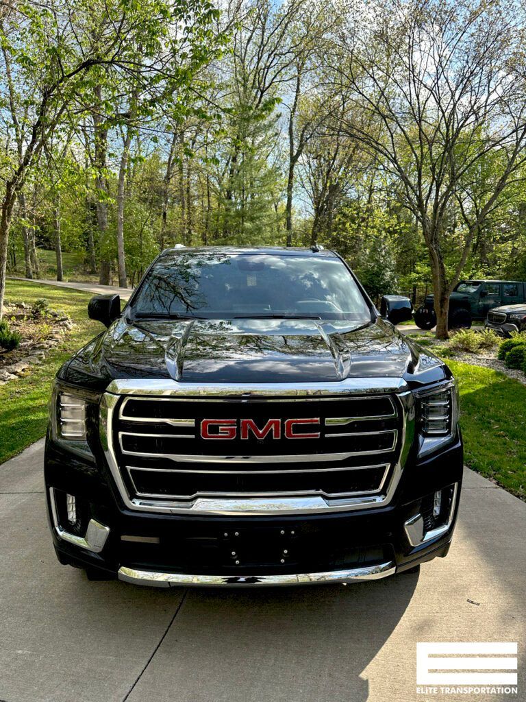 a black gmc truck is parked in a driveway