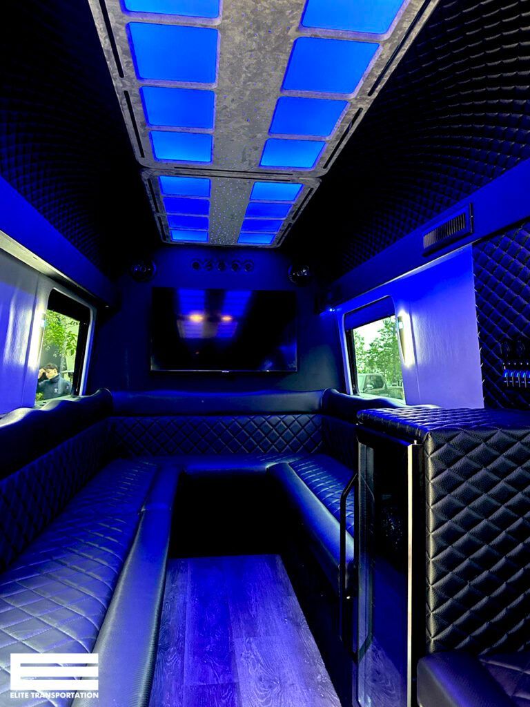 the inside of a shuttle bus with blue lights on the ceiling