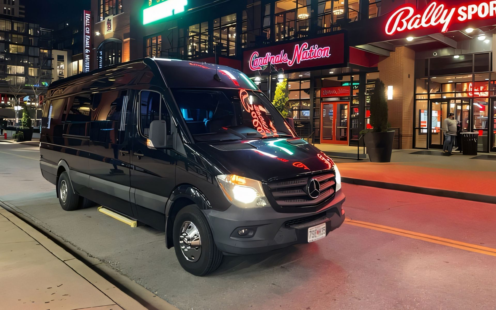 A black bus is parked on the side of the road.