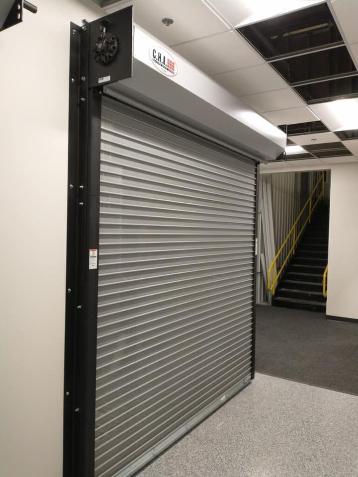 Gray rolling security door in a hallway.